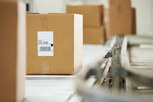 Goods Moving On Conveyor Belt In Distribution Warehouse